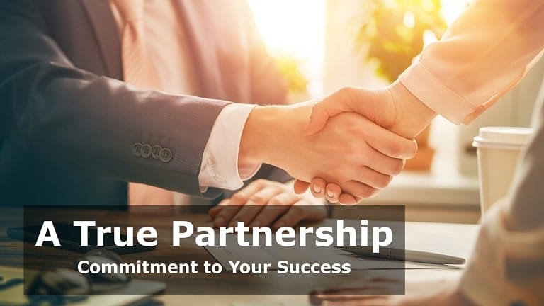 Partnership handshake across a desk